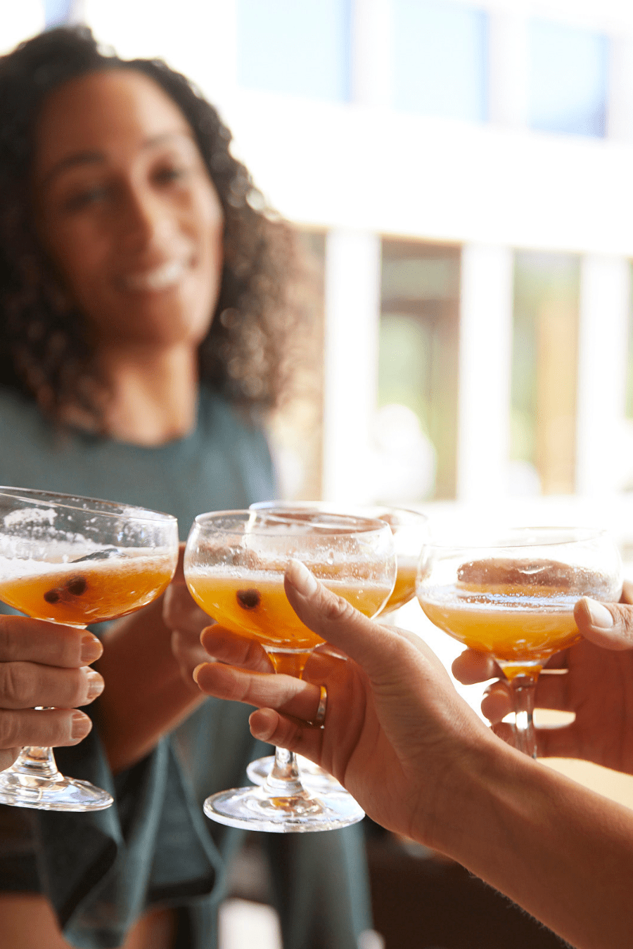 women cheering joyfully at a women’s wellness retreat