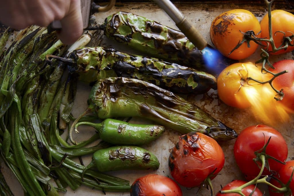 person torching vegetables