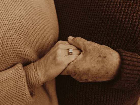 two people's hands holding