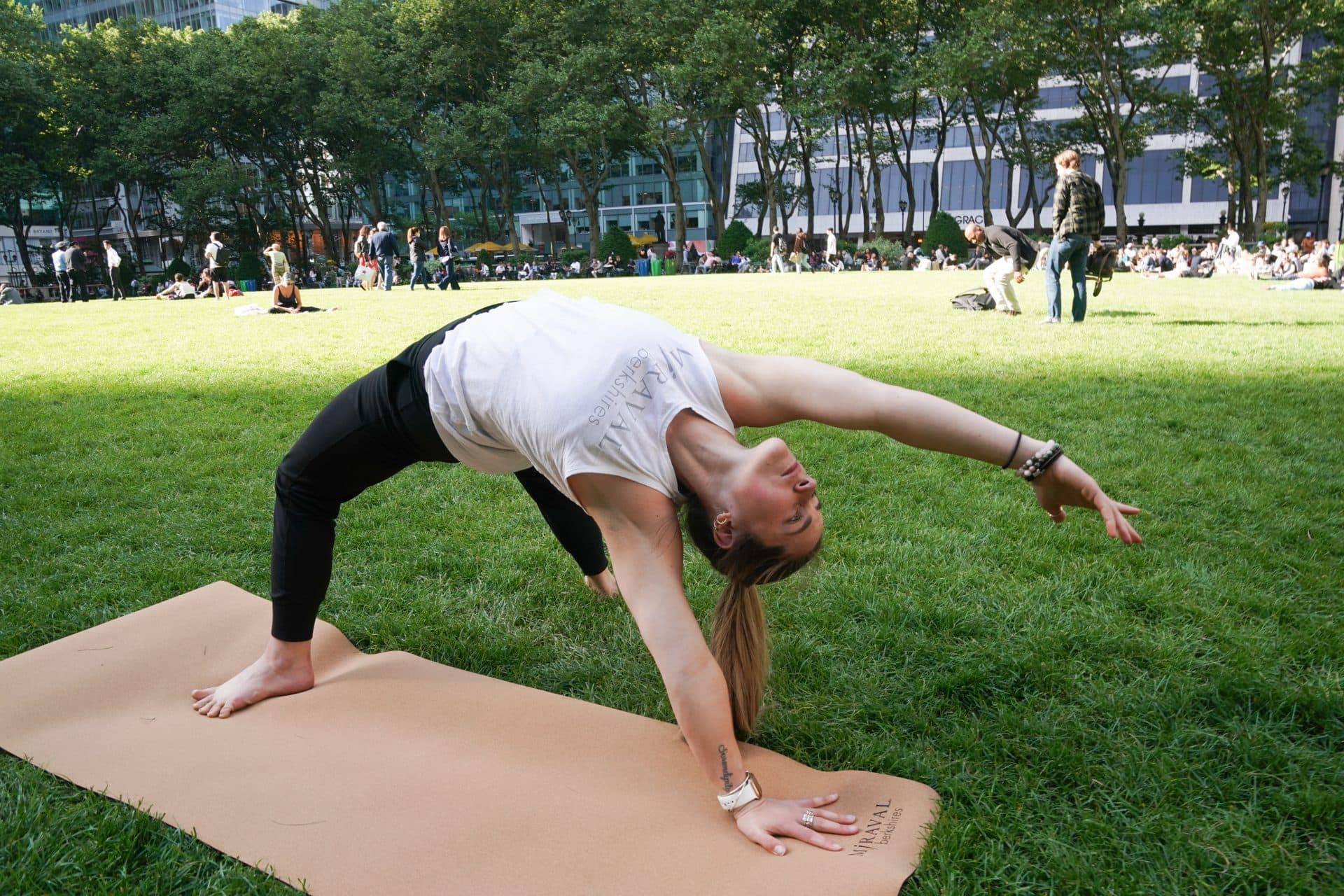 Woman doing outside yoga in park at yoga event